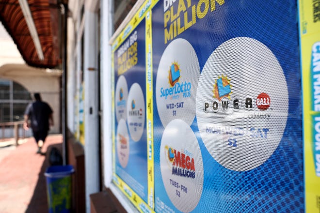 A California Lottery poster advertises Powerball and other lotteries Tuesday at a convenience store in Los Angeles, California.